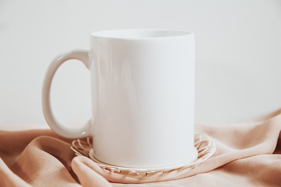 A white mug held above a woven coaster; illustrative stock photograph